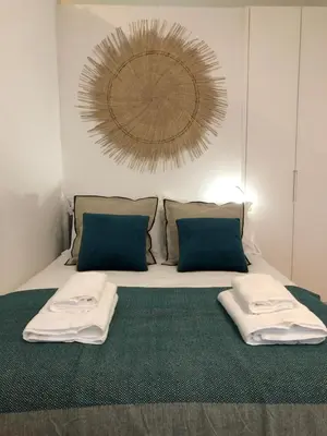 a bedroom with a bed with two towels on it at Central charming apartment in Porto