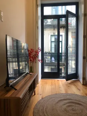 a living room with a fish tank and a large window at Central charming apartment in Porto