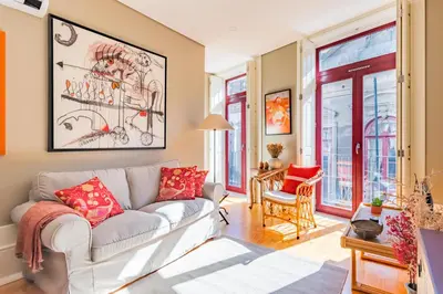 a living room with a white couch and red pillows at Oporto Viva la Vida Central apartment in Porto