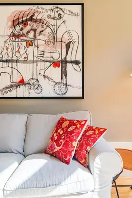 a living room with a couch with red pillows at Oporto Viva la Vida Central apartment in Porto
