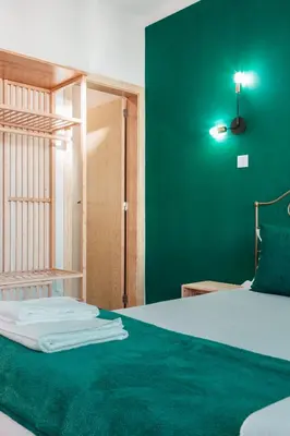 a green bedroom with a bed with a green wall at Campanha Apartment By Porto Stories in Porto