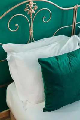 a bed with white pillows and a green wall at Campanha Apartment By Porto Stories in Porto