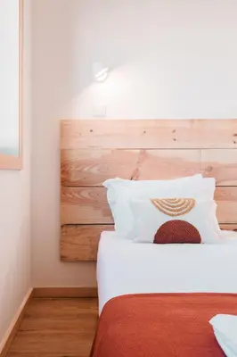 a bedroom with a bed with a wooden headboard at Campanha Apartment By Porto Stories in Porto