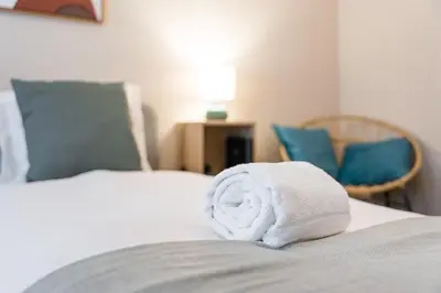 a stack of towels sitting on top of a bed at GuestReady - OPortoGrow Central Batalha 2 in Porto