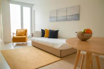 a living room with a couch and a table at room Select Porto Suites in Porto