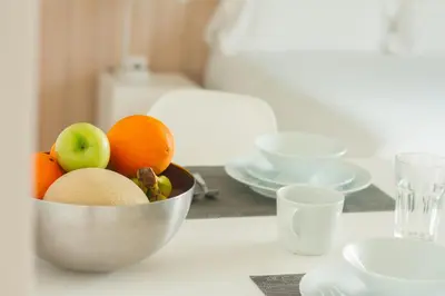 a bowl of fruit sitting on a table at room Select Porto Suites in Porto