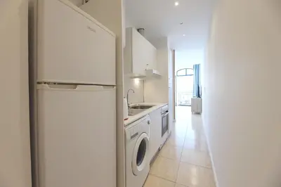 a kitchen with a refrigerator and a washing machine at FLH Porto Ribeira with River View in Porto