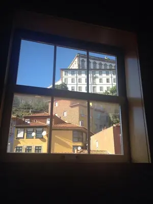 a window with a view of a building at FLH Porto Ribeira with River View in Porto