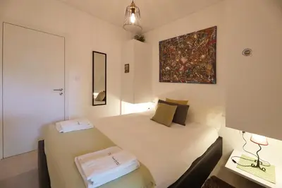 a bedroom with two beds and a painting on the wall at FLH Porto Santa Catarina Cosy Flat in Porto
