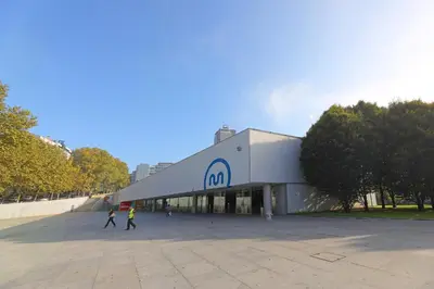 two people walking in front of a building at FLH Porto Classic Apartment with Terrace & Parking in Porto