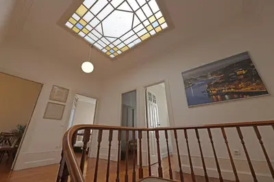 a room with a staircase with a stained glass window at FLH Porto Classic Apartment with Parking in Porto