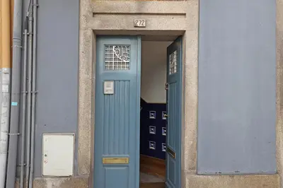 a blue door with a window in a building at FLH Porto Classic Apartment with Parking in Porto