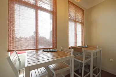 a dining room with a table and chairs and a window at FLH Porto Classic Apartment with Parking in Porto