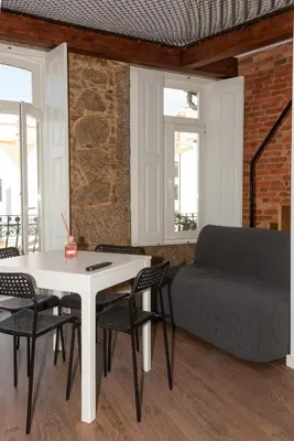a living room with a table and a couch at Fervença Great Stay Apartment in Vila Nova de Gaia