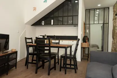 a kitchen and dining room with a table and chairs at Fervença Great Stay Apartment in Vila Nova de Gaia