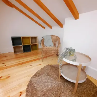 a living room with a table and a chair at A Window to Porto St. Helena in Porto