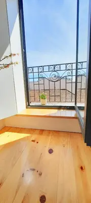 a room with a large window and a wooden floor at A Window to Porto St. Helena in Porto