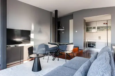 a living room with a blue couch and a table at MY DOURO VIEW Stylish Gem River Front in Massarelos