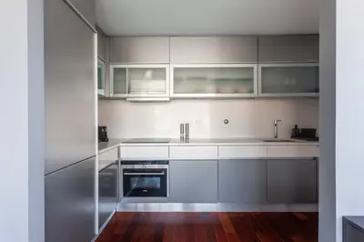 a kitchen with white cabinets and stainless steel appliances at MY DOURO VIEW Stylish Gem River Front in Massarelos