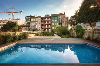 a swimming pool in front of some buildings at Swimming Pool Luxury House, with AC Downtown Porto in Porto