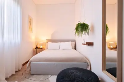 a small bedroom with a bed and a mirror at ! Bright 2BR Hammock Flat ! Praça da República in Porto