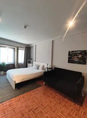 a bedroom with a bed and a couch in it at Oporto Batalha Nice View Flat in Porto