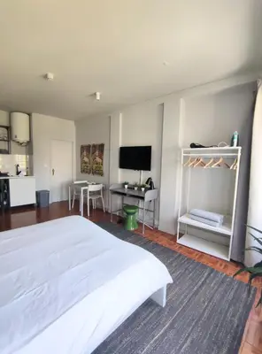 a bedroom with a white bed and a desk at Oporto Batalha Nice View Flat in Porto