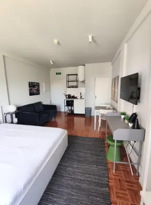 a bedroom with a bed and a living room at Oporto Batalha Nice View Flat in Porto