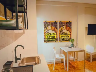 a kitchen with two posters on the wall and a table at Oporto Batalha Nice View Flat in Porto