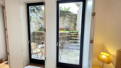 a pair of glass doors with a view of a patio at Sol Garden in Porto