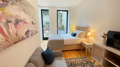 a bedroom with a bed and a painting on the wall at Sol Garden in Porto