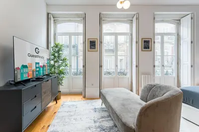 a living room with a couch and a tv at GuestReady - Amazing Studio in the heart of Porto in Porto