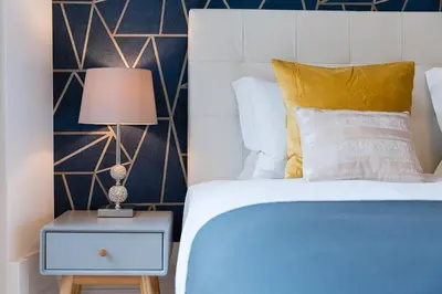 a bedroom with a bed and a lamp on a nightstand at GuestReady - Amazing Studio in the heart of Porto in Porto
