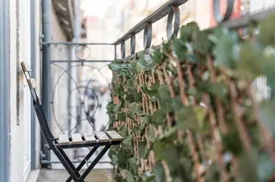 a bench sitting on a balcony next to a plant at GuestReady - Amazing Studio in the heart of Porto in Porto