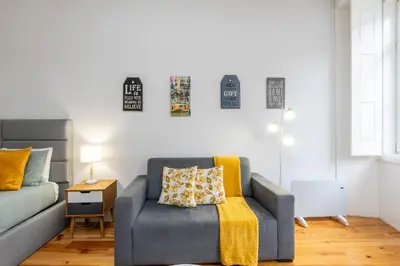 a living room with a couch and a chair at A Window to Porto - Premium apartment by the River in Porto