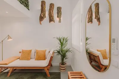 a living room with a couch and a mirror at Nature Cosy Private House,w/AC Downtown near Metro in Porto