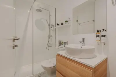 a white bathroom with a sink and a shower at Nature Cosy Private House,w/AC Downtown near Metro in Porto