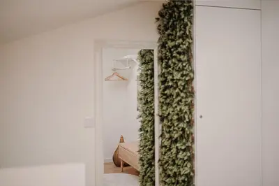 a room with a wall covered in green ivy at Nature Cosy Private House,w/AC Downtown near Metro in Porto