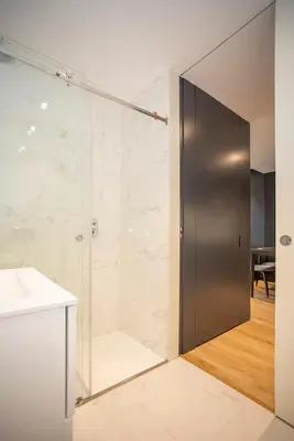 a shower with a metal door in a bathroom at Liiiving in Porto - Dragão Pool View in Porto