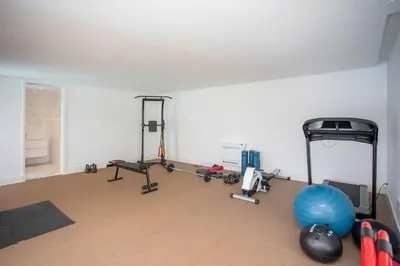an empty room with a gym with exercise equipment at Liiiving in Porto - Dragão Pool View in Porto