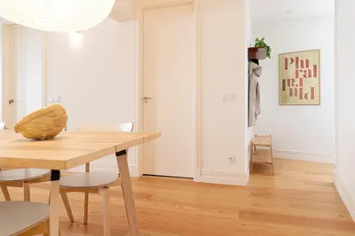 a dining room with a wooden table and chairs at Taipas Townhouse 1865_Boutique Apart in Porto