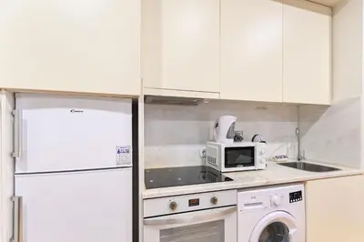 a kitchen with a white refrigerator and a microwave at BmyGuest - Patio de Santa Catarina Apartment in Porto