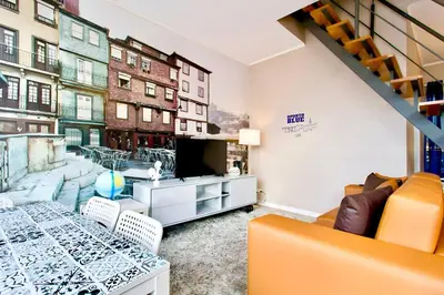 a living room with a table and a view of a city at Oporto Blue Lapa - Spacious Family Apartment With Winter Garden in Porto