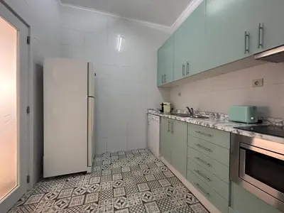 a kitchen with a refrigerator and a tile floor at Oporto Blue Lapa - Spacious Family Apartment With Winter Garden in Porto
