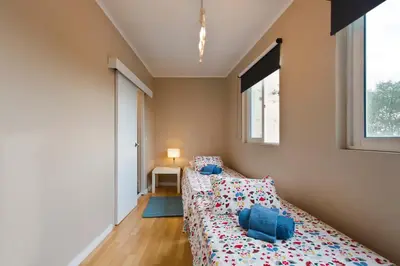 a bedroom with two beds and a window at Oporto Blue Lapa - Spacious Family Apartment With Winter Garden in Porto