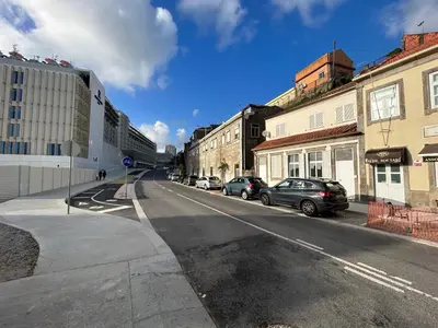 an empty street with cars parked on the side of the road at Oporto Blue Lapa - Spacious Family Apartment With Winter Garden in Porto