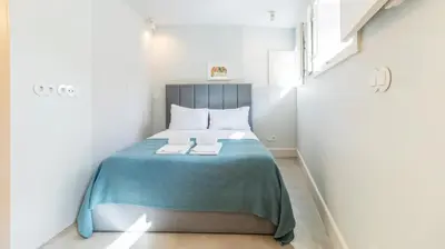 a small bedroom with a bed with two towels on it at Barros Lima 493 by LovelyStay in Porto