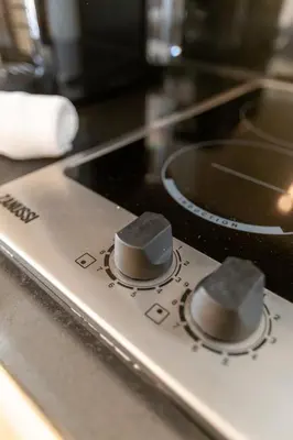 a stove top with two knobs on top of it at Welcome Aliados a Noble apartment in City Heart in Porto