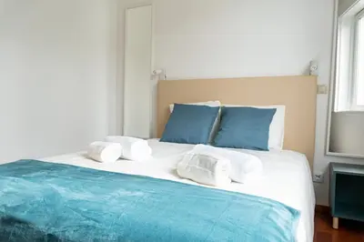 a living room with a tv and a window at Lovely Cedofeita Apartment by Unique Hosts in Porto