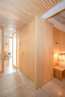 a room with a large wall of wood at Liiiving in Porto - Bolhão Trendy Apartments in Porto